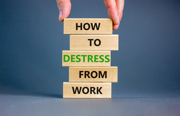 Destress from work symbol. Concept words How to destress from work on wooden blocks. Doctor hand. Beautiful grey background. Psychological business and destress from work concept. Copy space.