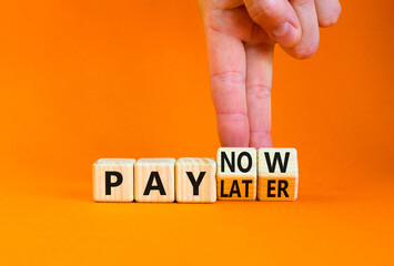 Pay later or now symbol. Businessman turns wooden cubes and changes concept words Pay later to Pay now. Beautiful orange table orange background. Business pay later or now concept. Copy space.