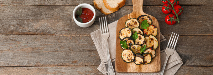 Composition with tasty grilled zucchini on wooden background