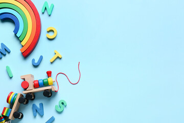 Toy train with building blocks and letters on blue background