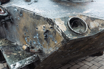 Bullet holes in Rusty russian tank burned by the Ukrainian military during Russian invasion of Ukraine in 2022. Downtown of Kyiv, capital of Ukraine.