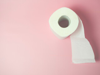 Toilet paper roll on pink background, Space for text