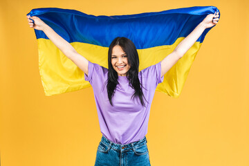Portrait of nice beautiful lovely glad cheerful woman holding in hands Ukrainian flag having fun...