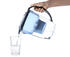 Woman pouring purified water into glass from blue filter jug on white background