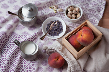 peach dessert ingredients on a purple fabric background
