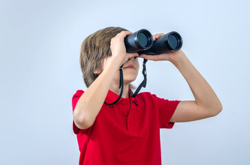 Kid with binoculars looks sideways
