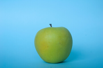 green apple with cyan background