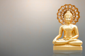 Gold buddha statue on gray background.