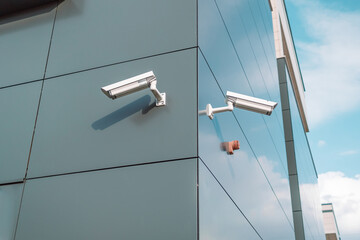 CCTV cameras are installed on the wall of business build