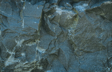 Silver Wall Rock background. Rock texture. Dark marble. Stone background. Rock pile. Paint spots. Rock surface with cracks. Grunge Rough structure. Abstract texture.