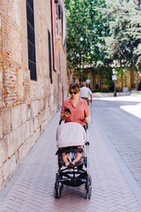 young mother takes a walk with young baby