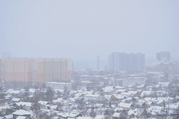 A snow-covered city without people with high-rises.