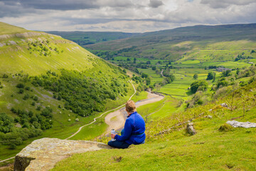 On the Coast to Coast long distance footpath walk at Muker in Swaledale in the Yorkshire Dales