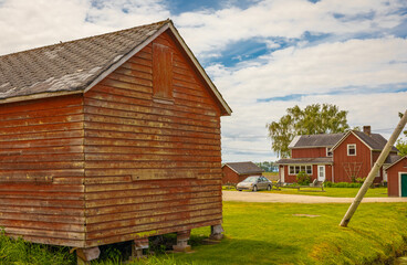 Typical North American Country Farm House in overcast day. Farm yard with the house and red barn.