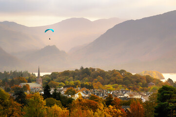 Lake District National Park, Cumbria, England. Paraglider over Keswick town and Derwentwater. South...