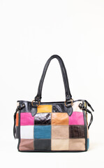 Patched multicolor female hand bag with two handles on white background isolated