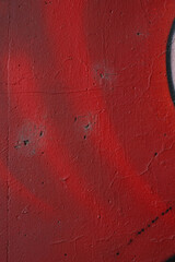 Fragment of the wall with shades of red graffiti painting. Part of colorful street art graffiti on...