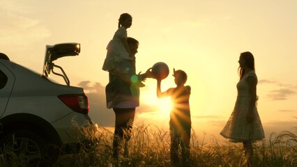 Father mother child play with ball rays sun laugh joyfully. Happy family playing with ball near car sunset. childhood dream trip. kid with parents picnic forest. silhouette happy family with children.
