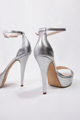 Sexy women silver high heels with open toe on a white background. leather, on platform