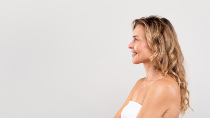 Profile Shot Of Beautiful Smiling Middle Aged Woman Standing Wrapped In Towel