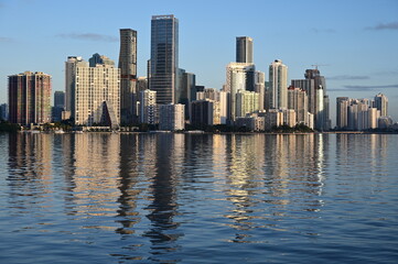 Fototapeta na wymiar Skyline of City of Miami, Florida reflected in calm water of Biscayne Bay on clear sunny morning.