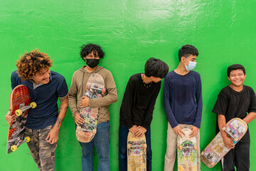 Group of Latino skater friends turning to see the youngest of the team in Managua, Nicaragua © Carlos