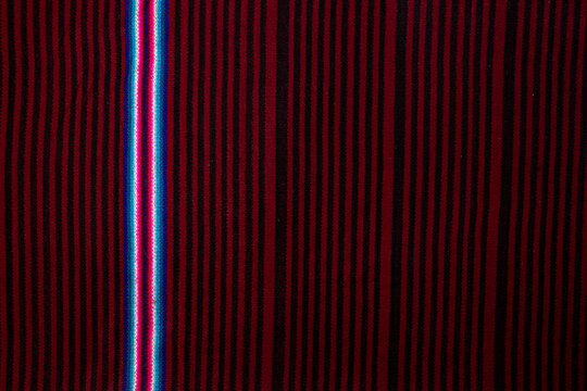 Fabric, Andean cloth. Andean culture of Bolivia texture background red, black, blue and white. Autochthonous antecedents of the culture of the Andes in the Latin American Altiplano