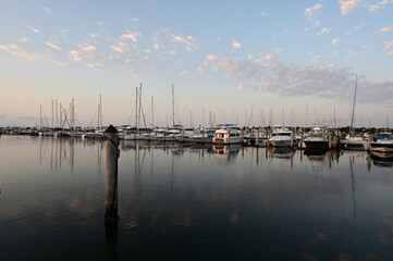 Suummer cloudscape reflected in tranquil water of Dinner Key Marina in Coconut Grove, Miami,...