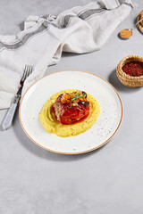 Eastern cuisine - stuffed paprika with mashed potatoes. Stuffed pepper with pure on ceramic plate in contemporary style. Modern concept eastern food menu. Aesthetic composition with main course.