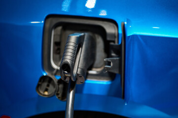 Charging electric automobile with plug at power station