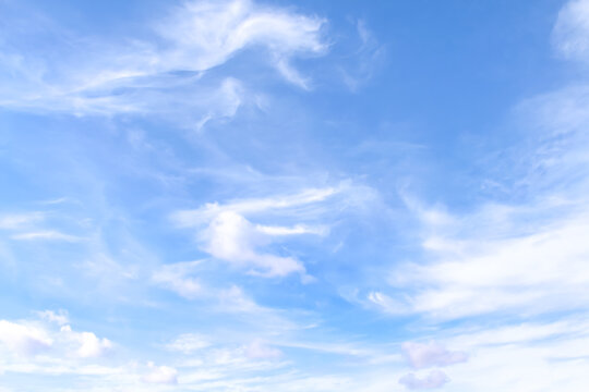 Vast blue sky with soft white clouds and light wind patterns on  scenic summer background