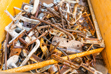 Diverse old rusty scrap metal from small items close-up