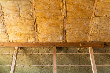 Comparison of mineral and glass wool in one frame. Roof insulation technology. Sheet insulation