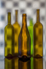 Still life with colored glass bottles on a blurry background