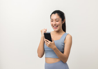 Naklejka premium Happy Beautiful young asian sporty woman using smartphone mobile standing on isolated white background. Good shape woman wearing sportswear holding cell phone.