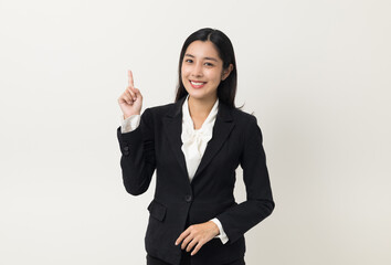 Young asian business woman smiling to camera standing pose on isolated white background. Female around 25 in suit portrait shot in studio.