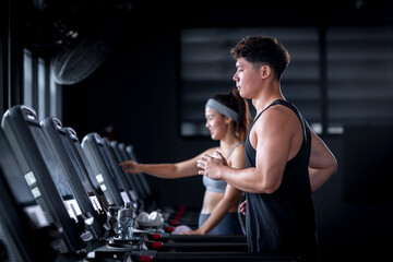 Asian beautiful sport woman wearing sportwear with workout headband under exercise on treadmill machine gym is sport healthy body building in fitness lifestyle