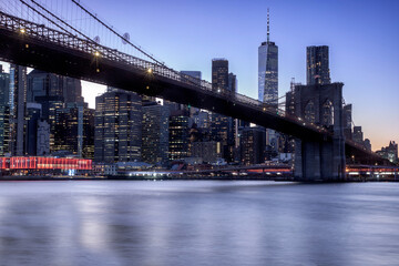 The Lower Manhattan skyline and the Brooklyn Bridge seen at twilight from Brooklyn