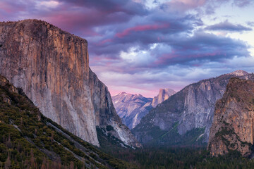 Evening view of Yosemite National Park seen from the Tunnel View overlook.  Seen are Half Dome and El Capitan