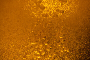 Lager beer bubbles close up motion abstract background
