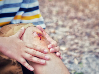 The boy was in an accident with a knee injury. The wound should be cleaned to prevent serious...