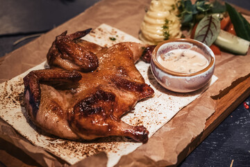 Baked chicken gherkin with fresh vegetable salad, mashed potatoes and creamy mushroom sauce on wooden cutting board