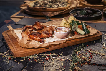 Baked chicken gherkin with fresh vegetable salad, mashed potatoes and creamy mushroom sauce on wooden cutting board