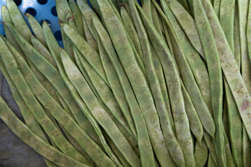 Fresh green or string beans in a tray in the supermarket. Green string beans. Top view