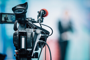Camera Recording at a Press Conference.