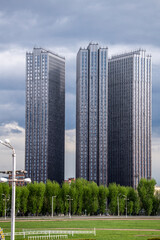 landscape with high-rise buildings on a summer day against a blue sky