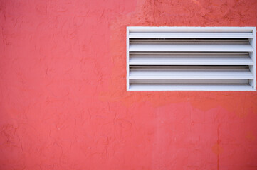 Flamenco Pink Adobe Wall with a  White Window.