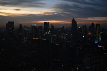 Naklejka na ściany i meble Jakarta city viewed from the top and at sunset