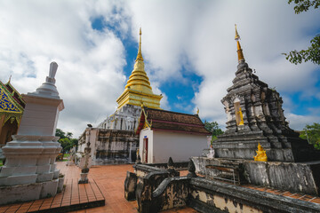 Naklejka premium The golden stupa at Wat Phra That Chang Kham Worawihan, or Phrathat Chang Kham Worawihan temple, is the one attraction and is famous in Nan province, Thailand.