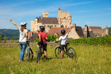 happy family by bike- Dordogne in France - obrazy, fototapety, plakaty
